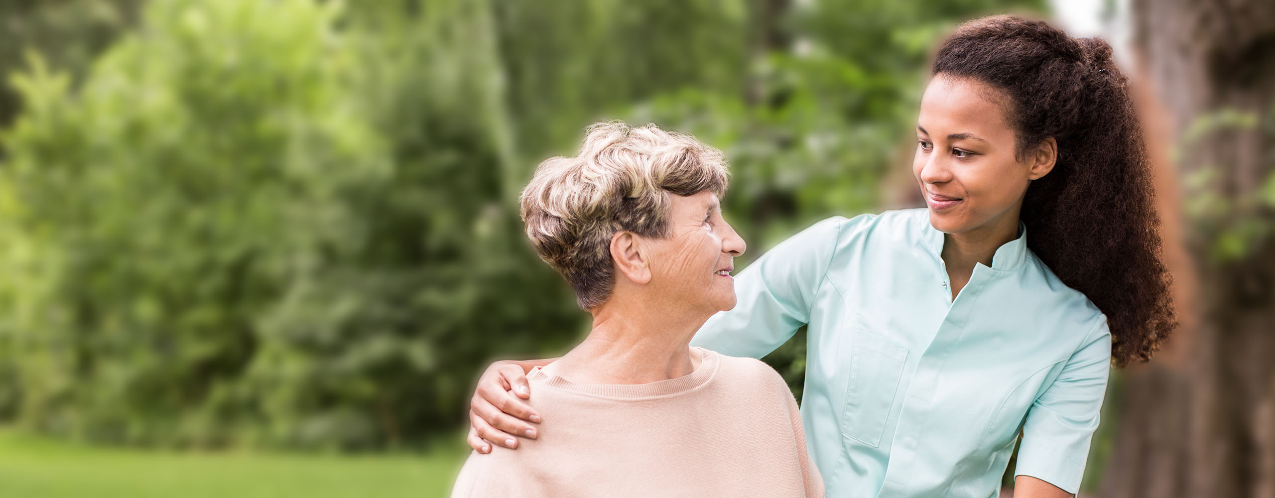 A Divine Mercy Caregiver Tending to Client in Her Backyard